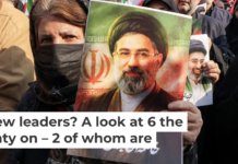 A woman poses with a picture of Iran’s new supreme leader, Ayatollah Mojtaba Khamenei, in central Tehran on March 9, 2026. Atta Kenare/AFP via Getty Images